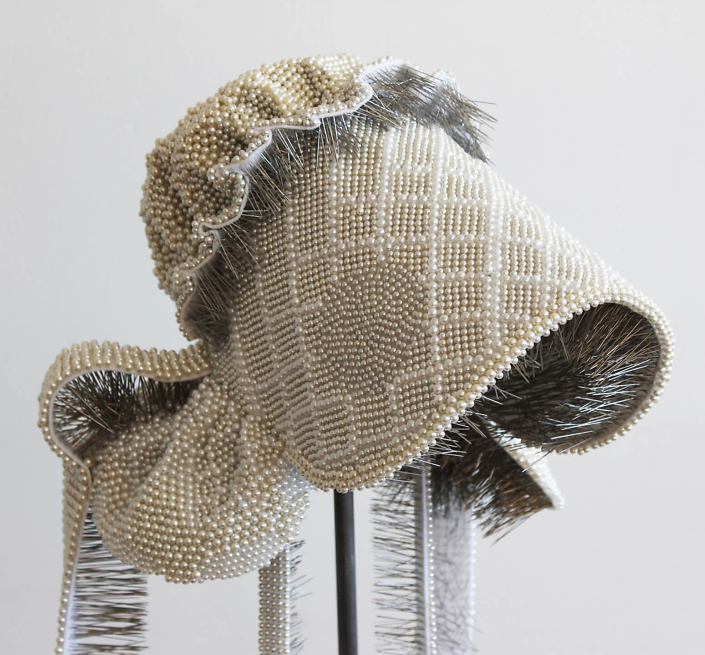 Angela Ellsworth - Seer Bonnet XIX (Flora Ann) (detail) (SOLD), 2011, 24,182 pearl corsage pins, fabric, steel, wood, 60 by 13 by 16 inches