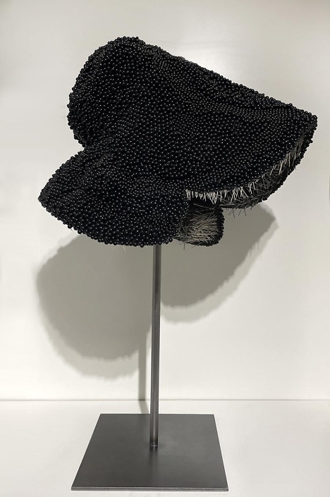 Angela Ellsworth - In Memory of our Sisters (SOLD), 2022 13,758 black dress pins and boutonnière pins, wood, fabric, steel 24”x 13" x 15”