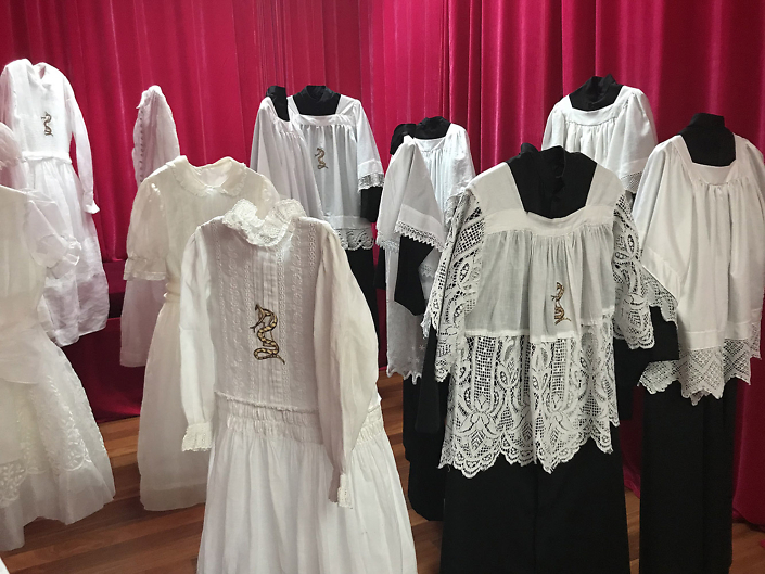 Trina MicKillen - The Children, 2015-2018, 20 communion dresses, 20 altar boy vestments, Irish linen, thread, gold leaf, dimensions vary