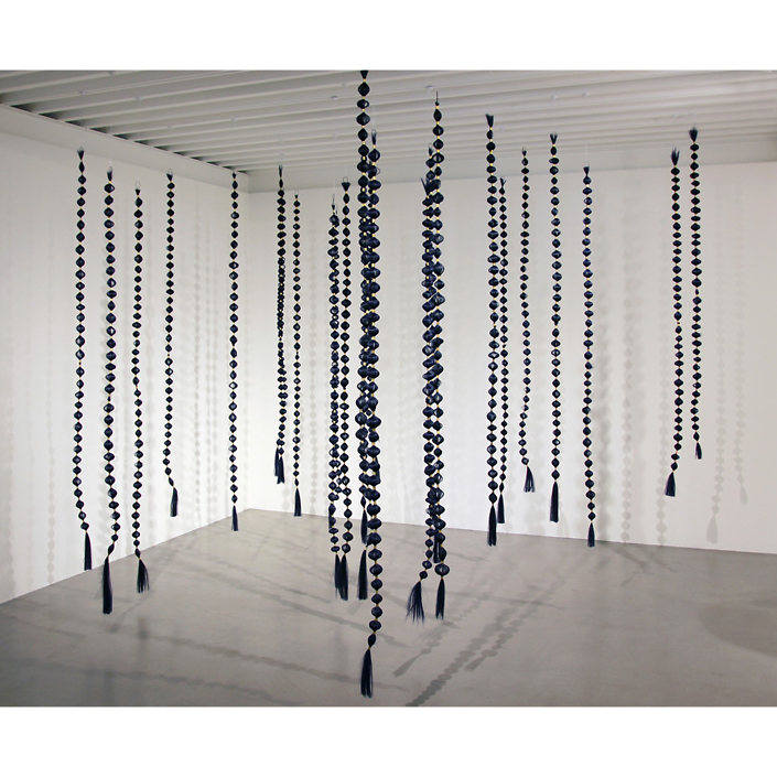 Merryn Omotayo Alaka & Sam Fresquez - I'm That Bitch, 2021, Kanekalon hair and braid clamps, steel wire, 75 by 2 by 2 inches each strand