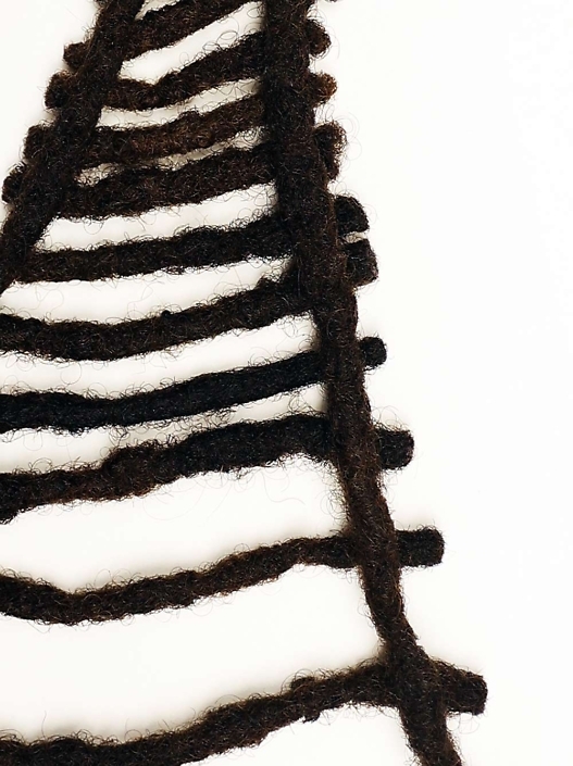 Sonya Clark- “Freedom was a community laboring for something lovely and rare.” – Colson Whitehead, The Underground Railroad (detail), 2017, human hair, 12" x 8.25" x .5" unframed