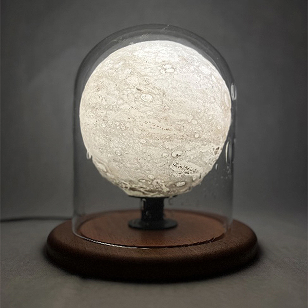 Charlotte Potter - Lantern, 2023, hand blown glass, regolith (lunar highlands simulant), metal, mahogany, electricity, 12" x 12" diameter